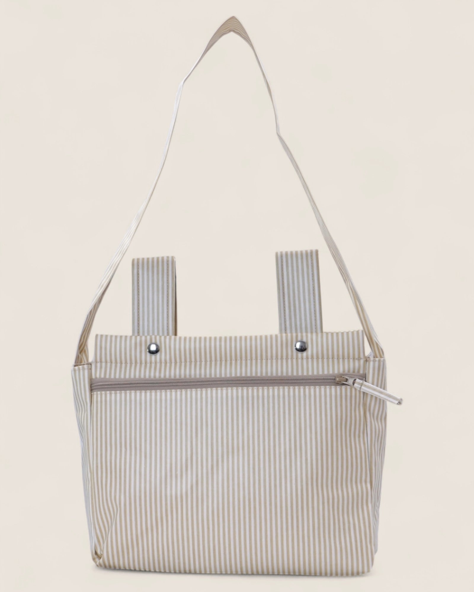 Striped sbaby troller bag with a shoulder strap on a light beige background