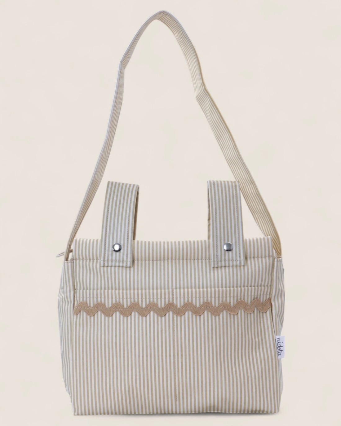 Beige striped baby stroller bag with a waved detail 
