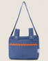 striped blue baby stroller bag with orange accents on a beige background