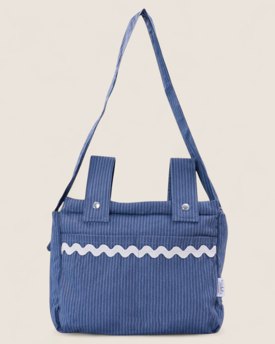 striped Blue baby stroller bag with a white waved design on a beige background