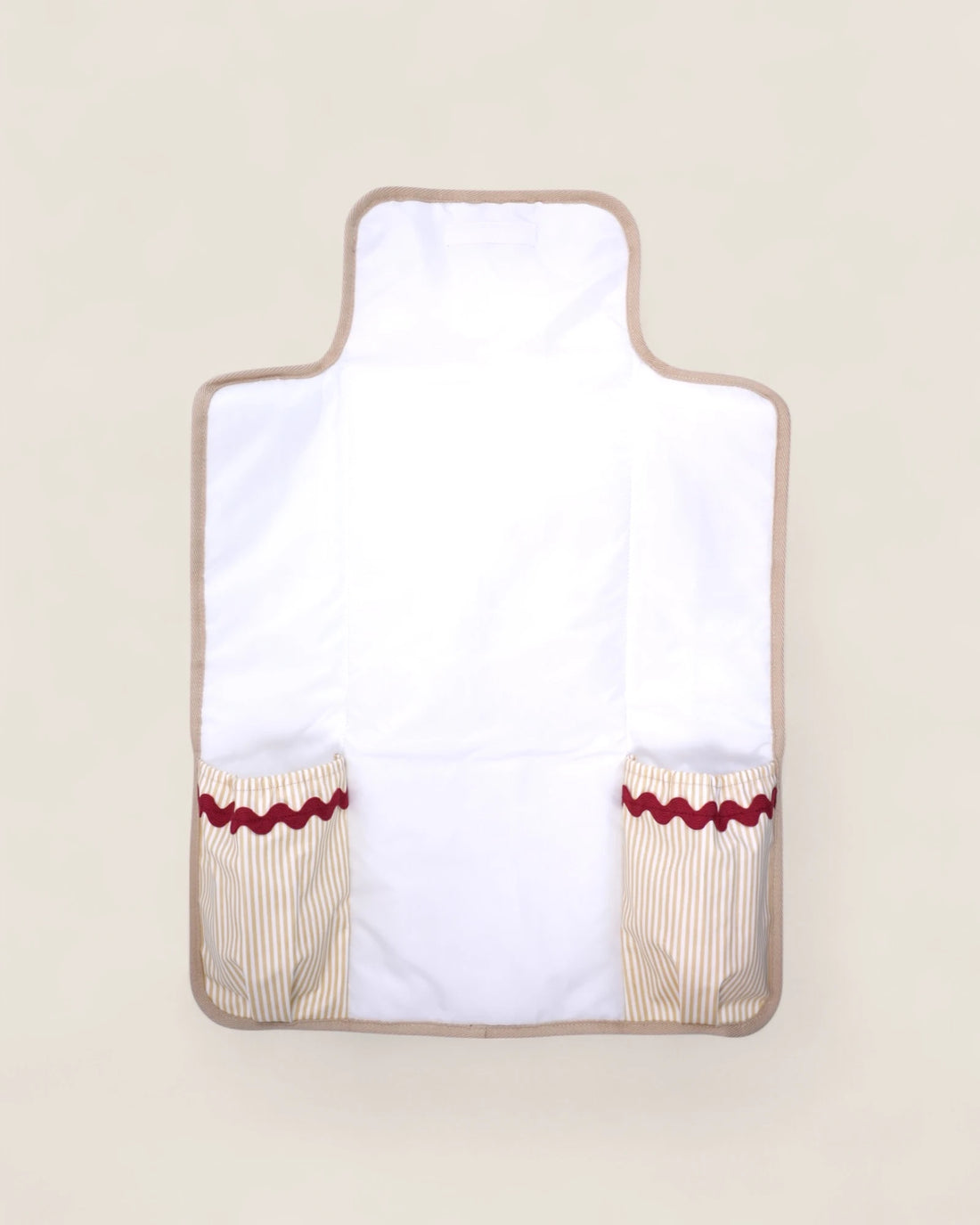 baby changing mat, opened, with pockets and red waved details