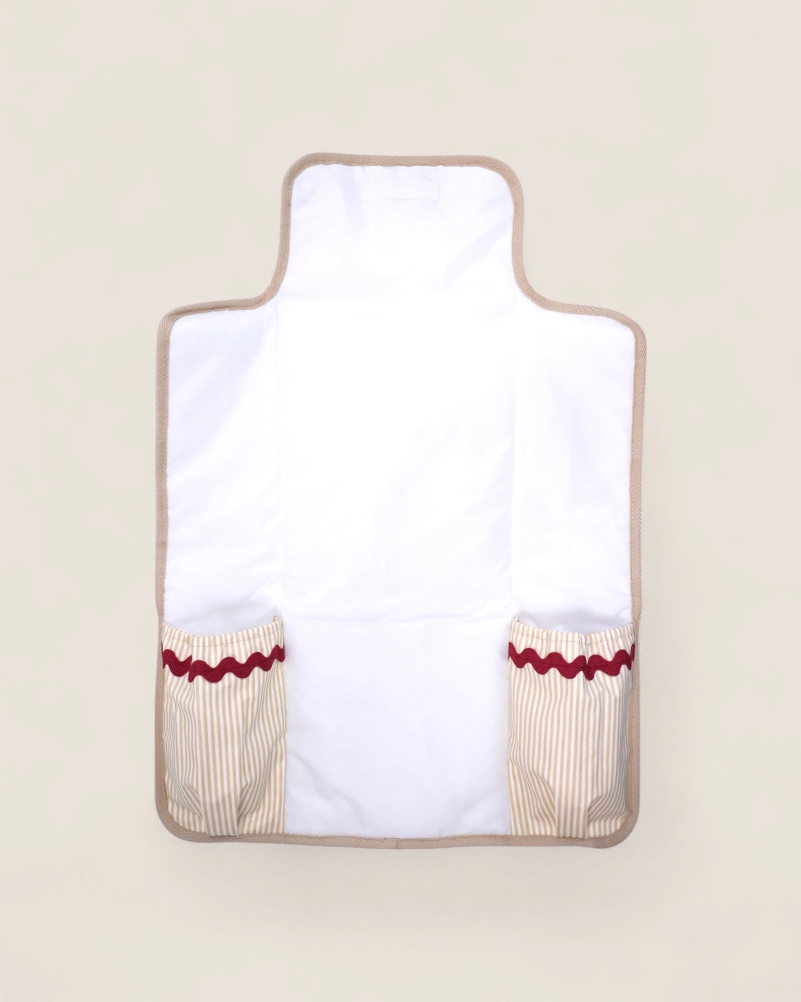 baby changing mat, opened, with pockets and red waved details