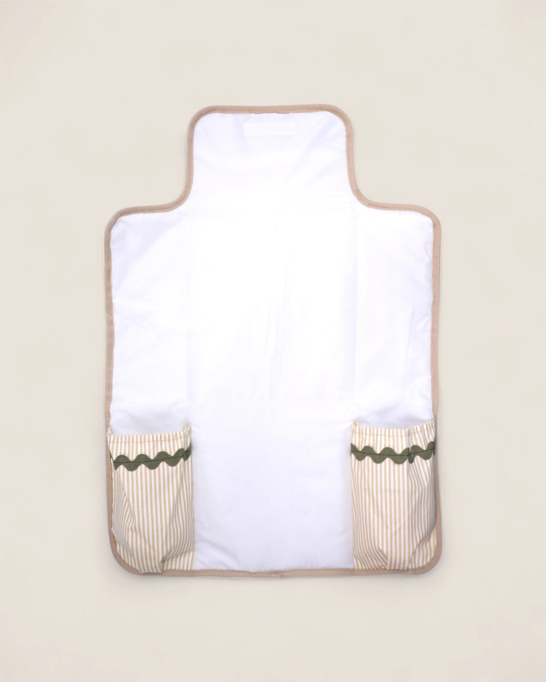 baby changing pad with beige border and green trim