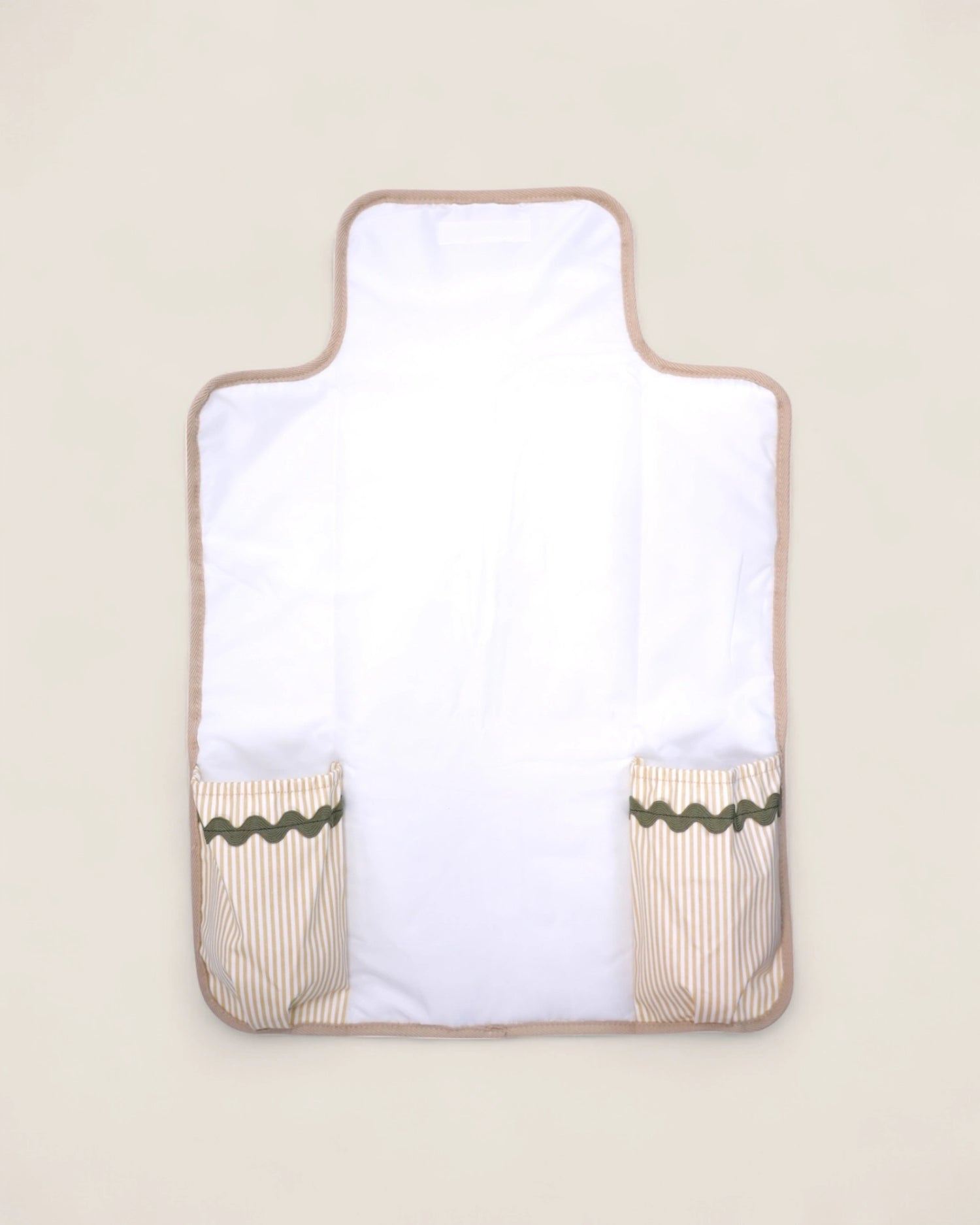 baby changing pad with beige border and green trim
