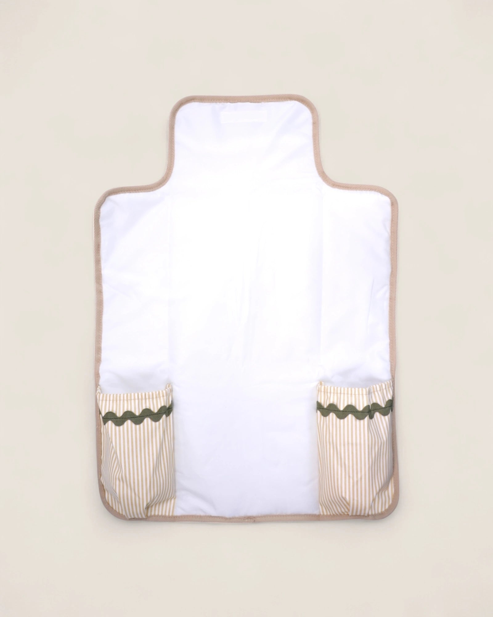 baby changing pad with beige border and green trim