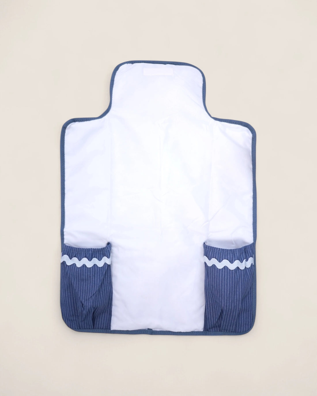 white baby changing mat opened with blue pockets for wipes and diapers 