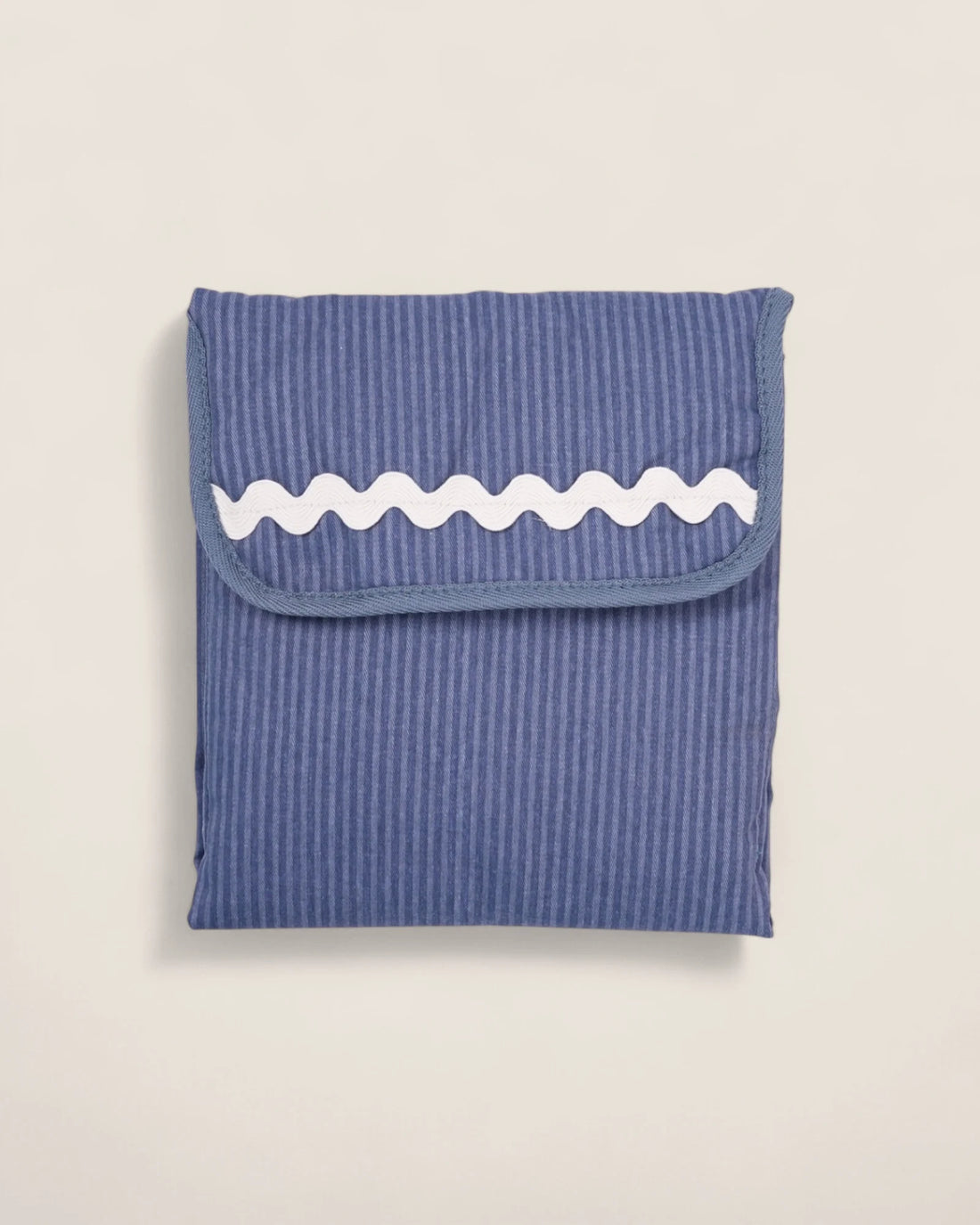 striped blue folded baby changing mat with white waved detail
