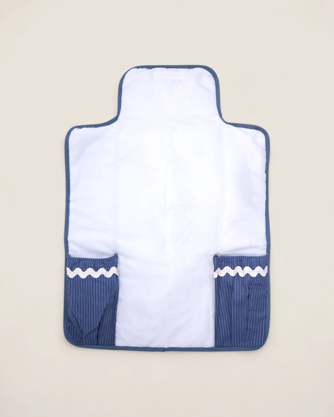 White baby changing mat with blue pockets