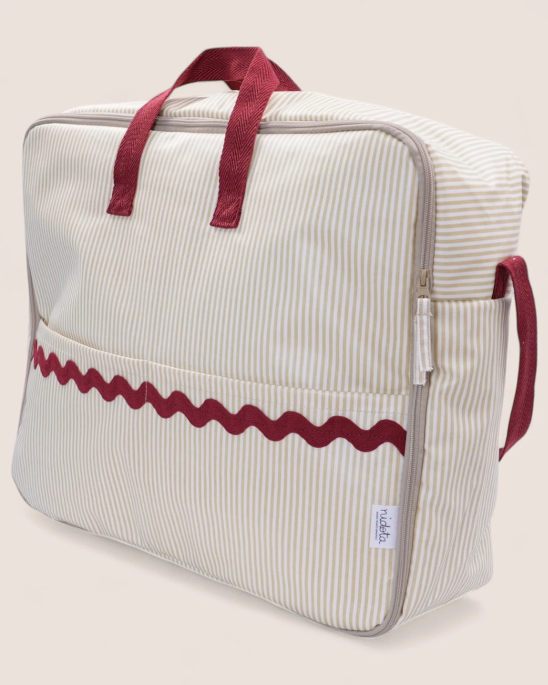 Striped beige maternity suitcase bag with red handles and red details