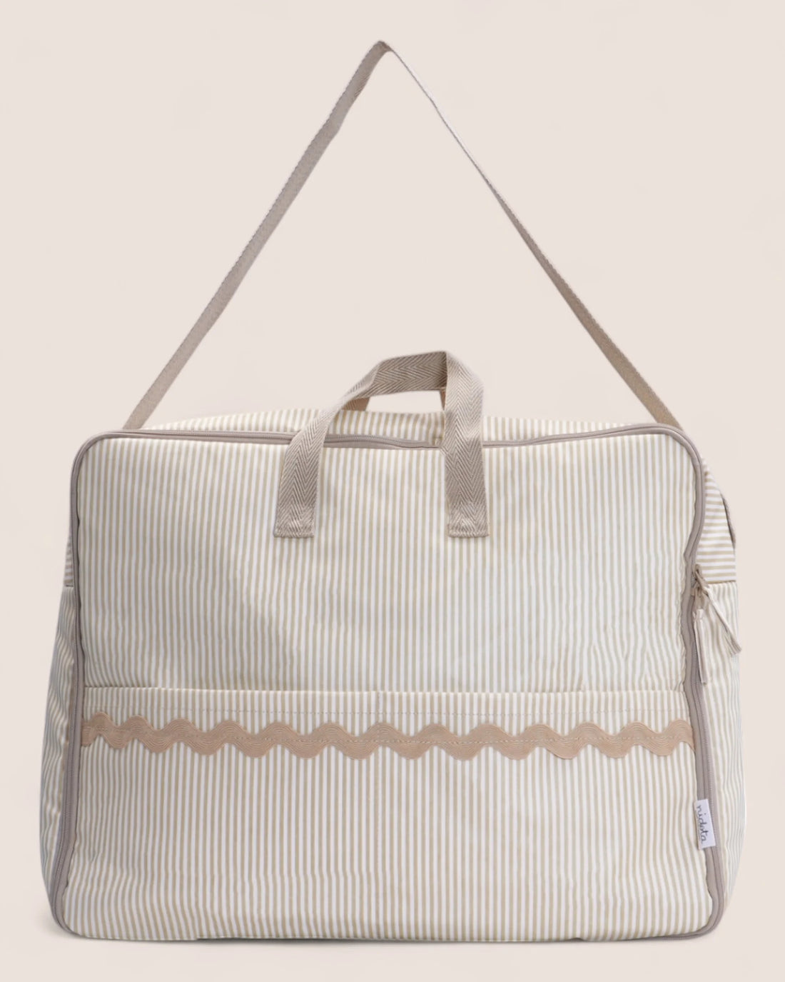 Striped maternity bag suitcase with a beige strap on a light background