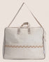 Striped maternity bag suitcase with a beige strap on a light background