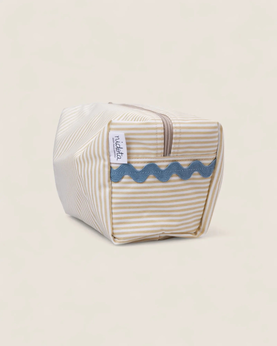 Striped toiletry bag with wavy pattern on a beige background
