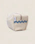 Striped toiletry bag with wavy pattern on a beige background