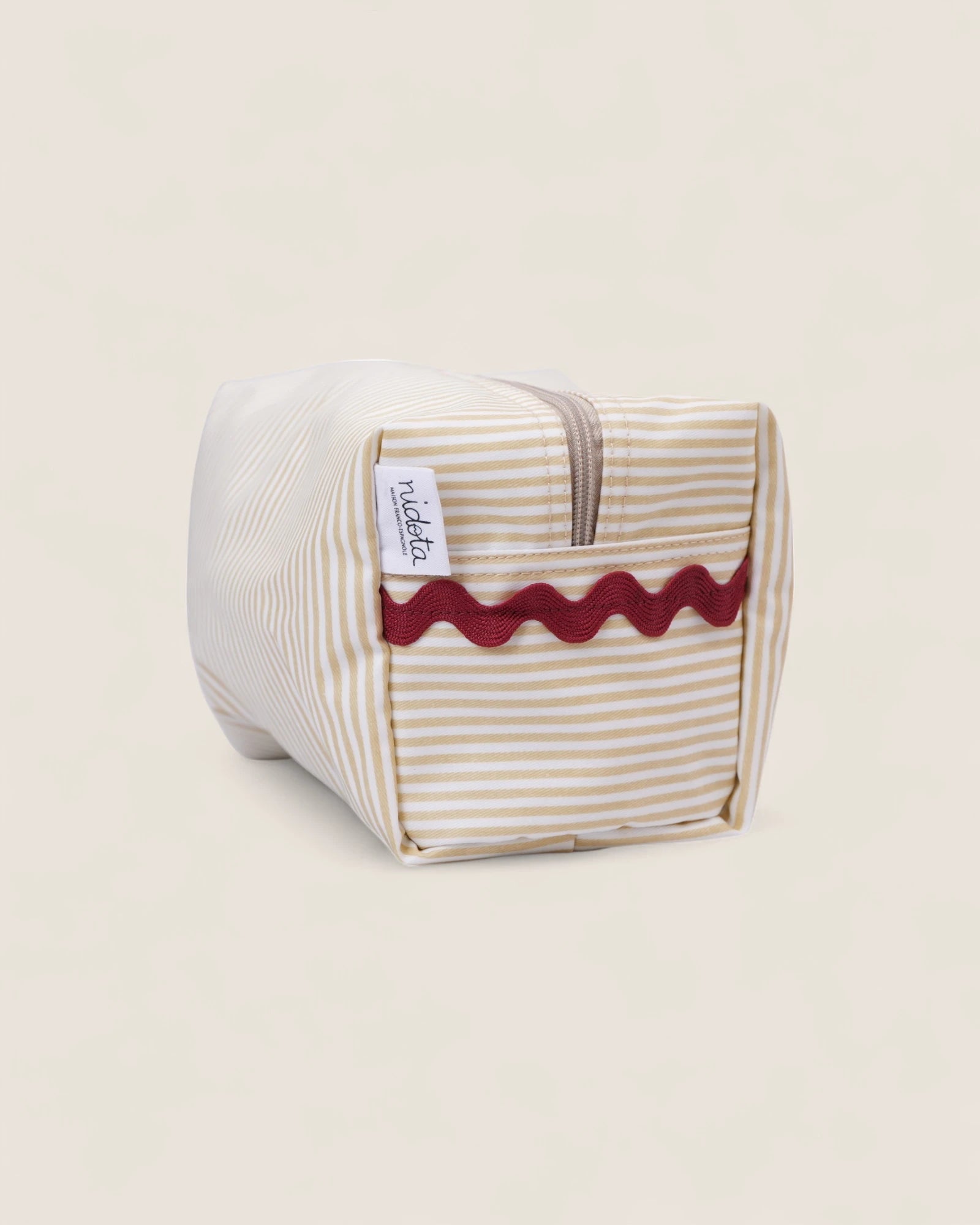 Striped beige toiletry bag with a red wavy design 