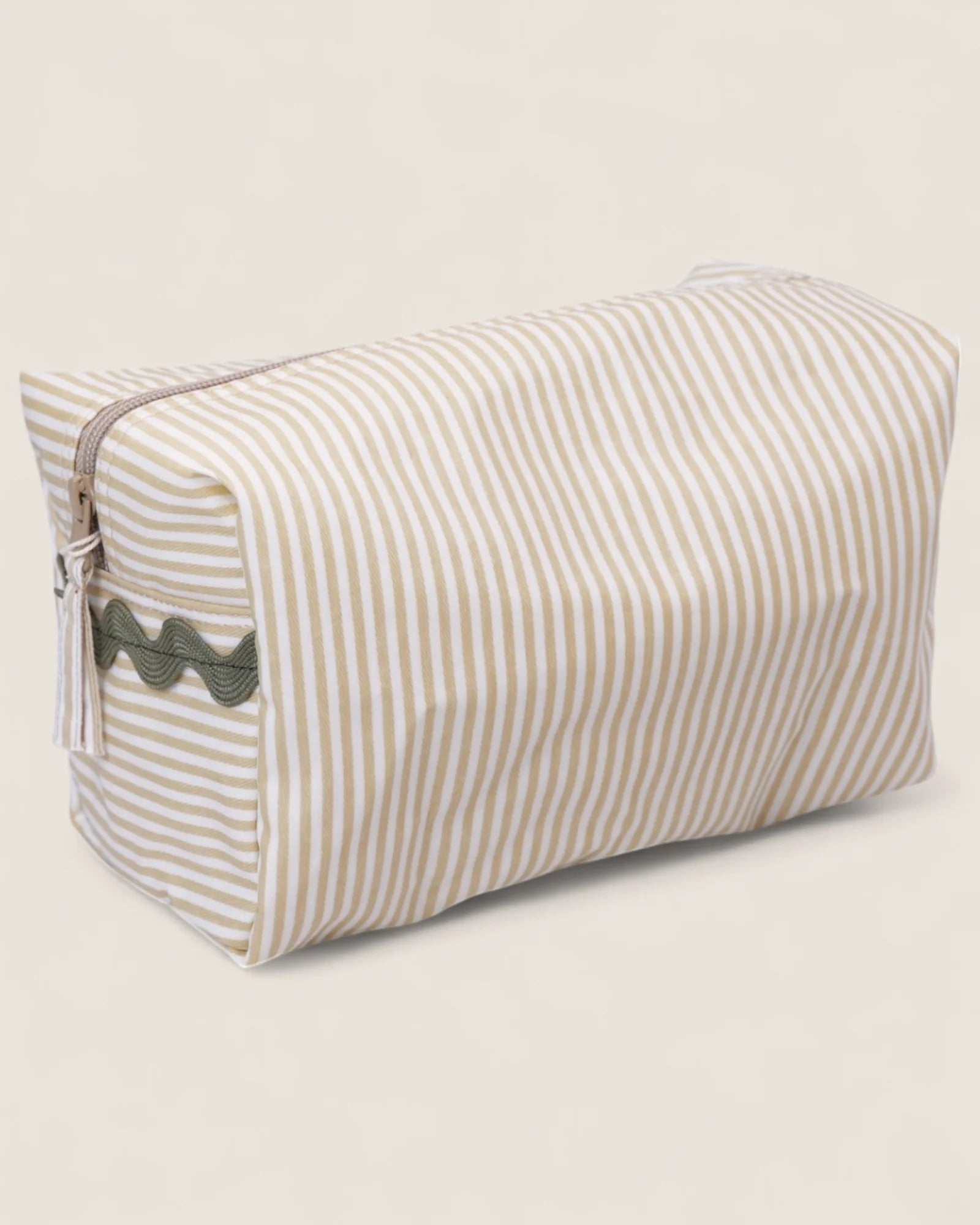 striped beige toiletry bag with a zipper and green details 
