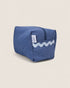 Blue striped toiletry bag with a light blue wave design on a beige background