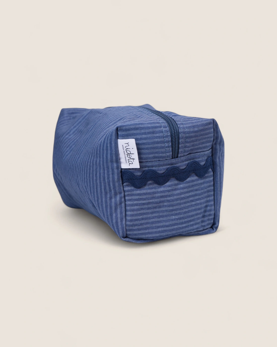Blue striped toiletry bag with a navy waved design