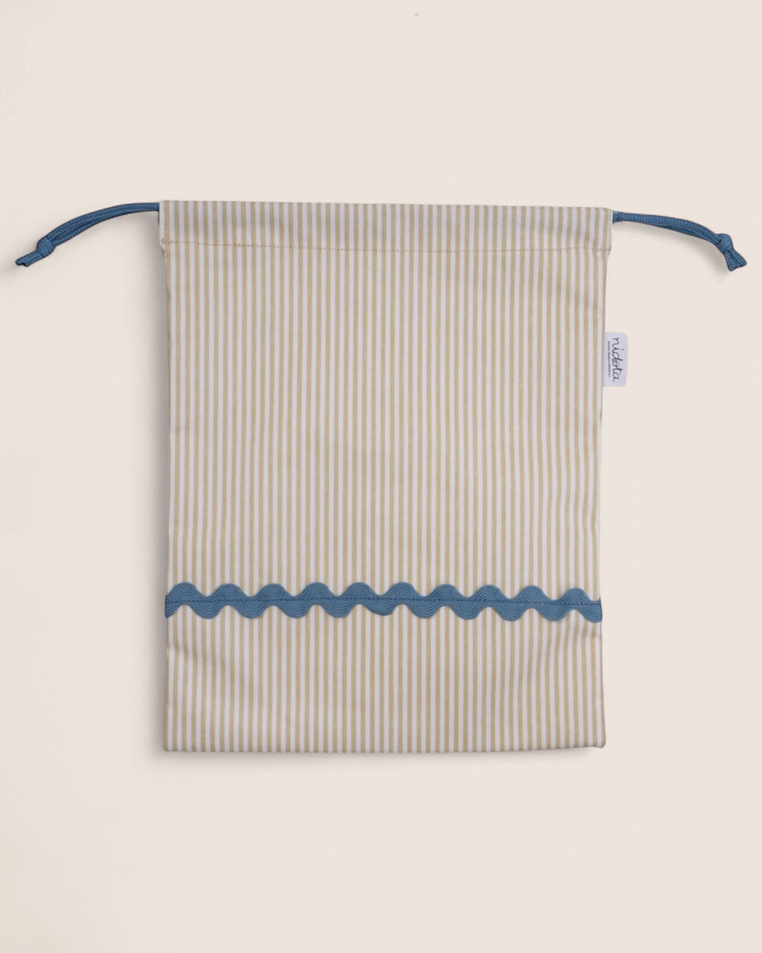Striped pouch with blue accents on a light beige background