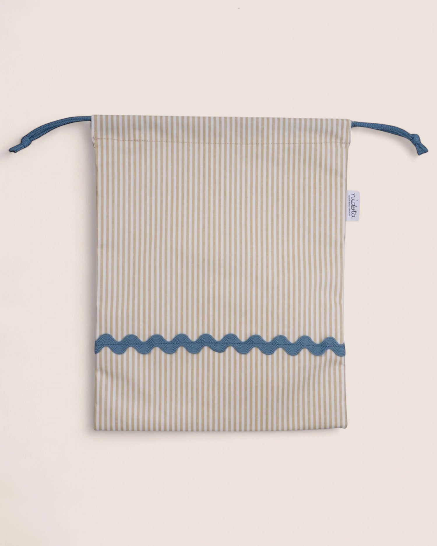 Striped pouch with blue accents on a light beige background