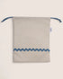 Striped pouch with blue accents on a light beige background