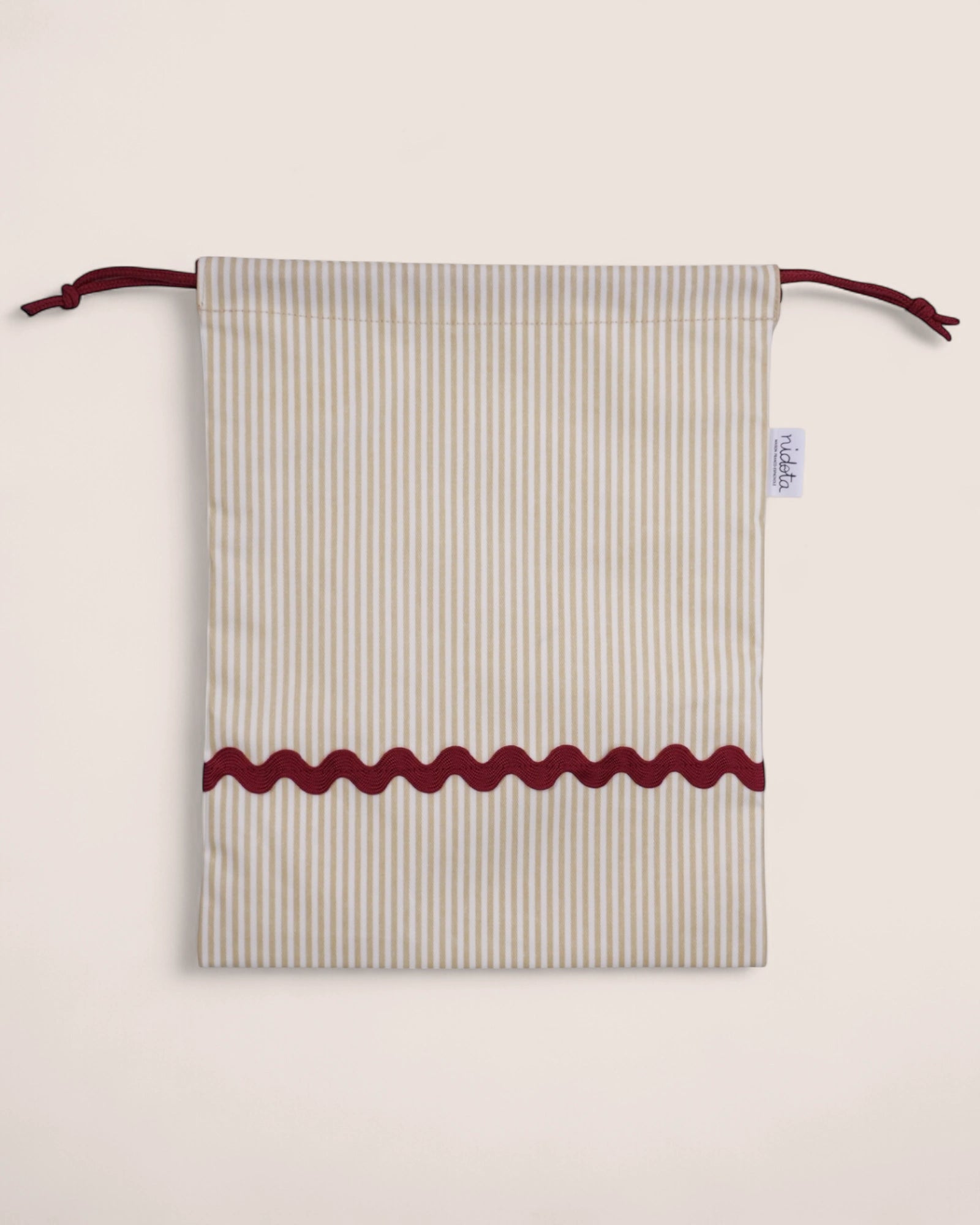 pouch bag with striped beige pattern and red waved details