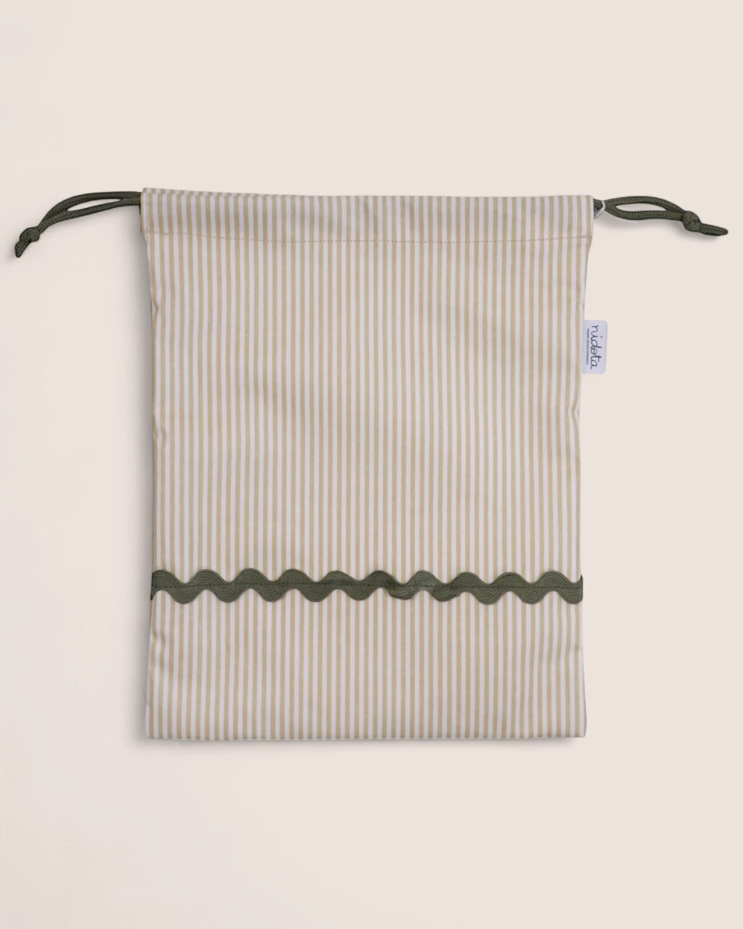 pouch bag with striped pattern and green details on a beige background