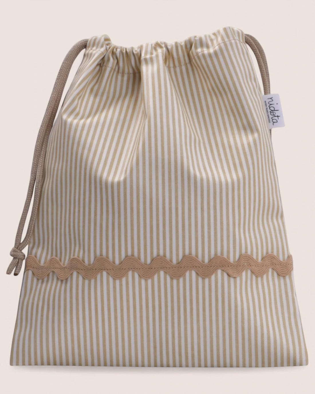 striped beige pouch bag with beige waved detail
