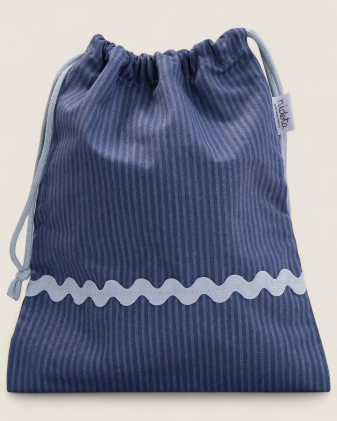 closed Blue striped pouch bag with light blue wavy line on a beige background