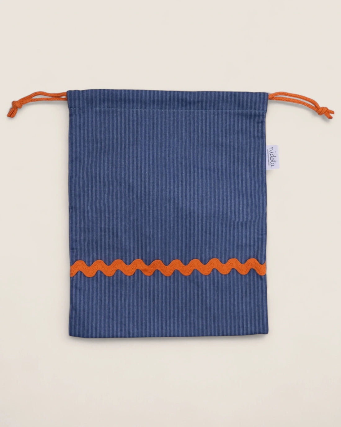 striped Blue pouch bag with orange waved design on a beige background