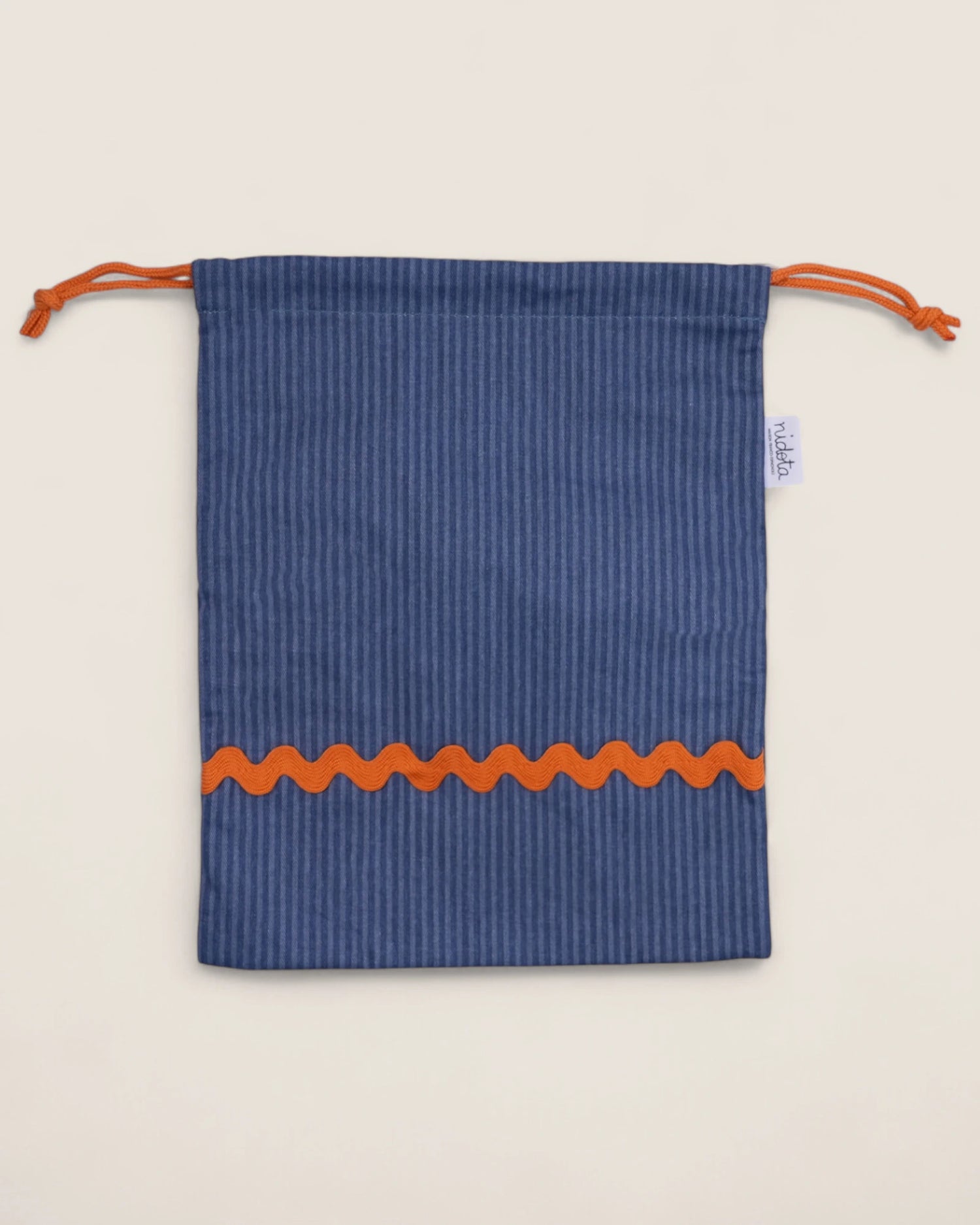 striped Blue pouch bag with orange waved design on a beige background