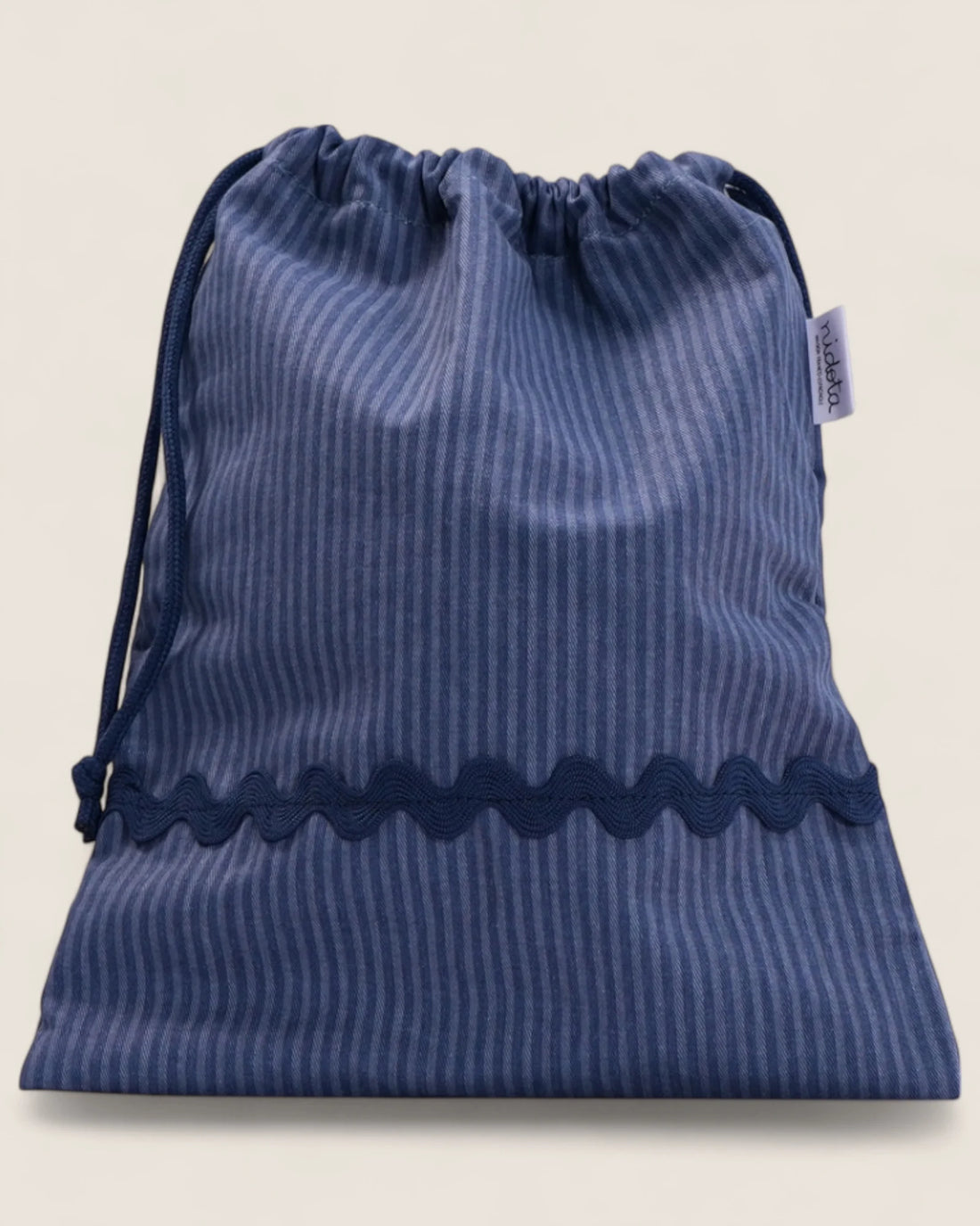 closed striped blue pouch bag with wavy navy design 
