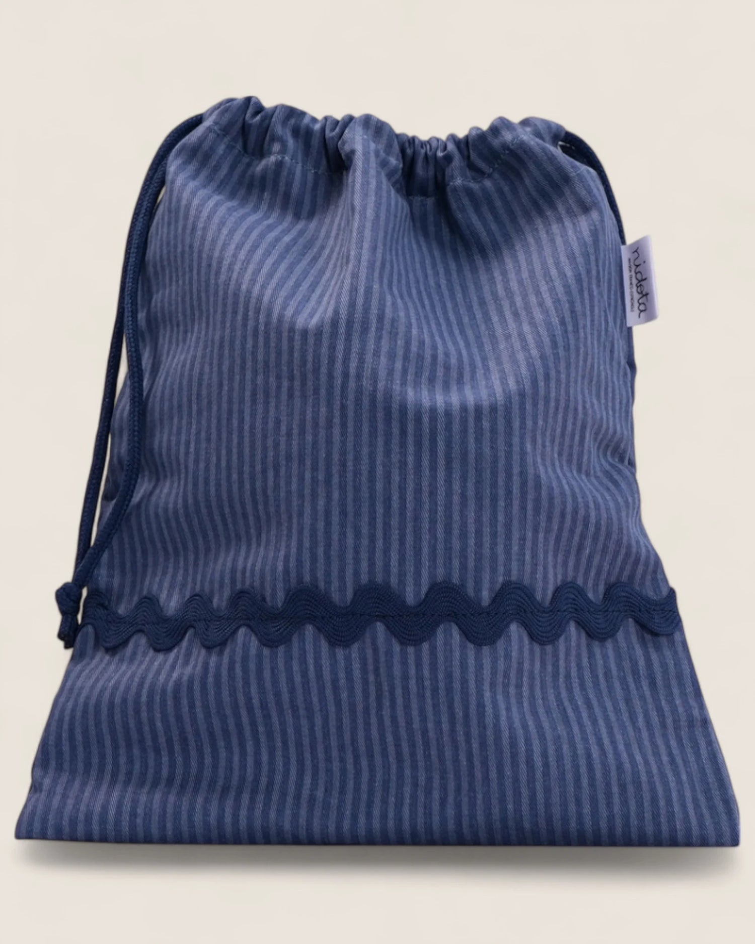 closed striped blue pouch bag with wavy navy design 
